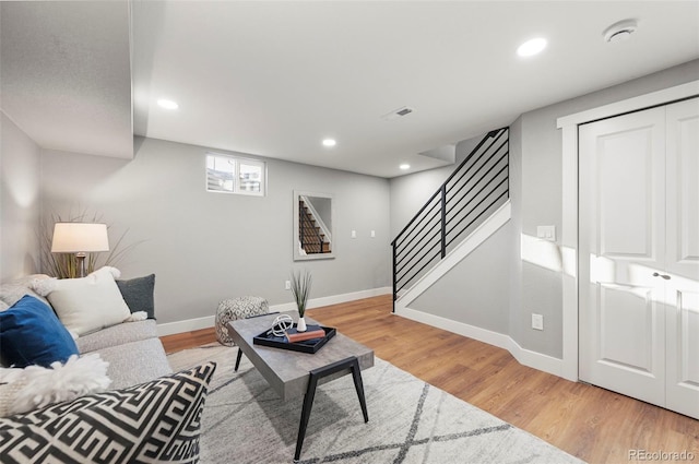 living room with stairway, baseboards, recessed lighting, and light wood finished floors