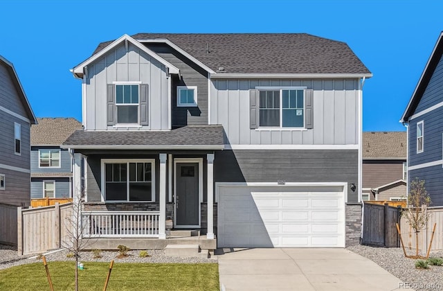 view of front of home with covered porch, an attached garage, board and batten siding, fence, and driveway