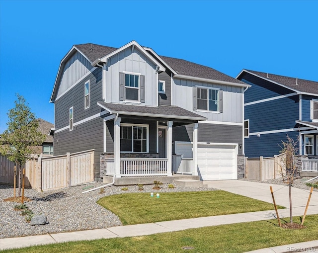 view of front of property with covered porch, a garage, fence, driveway, and board and batten siding