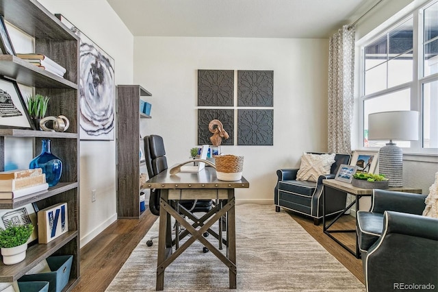 office area featuring baseboards and wood finished floors