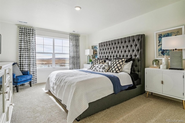 bedroom with light colored carpet and visible vents