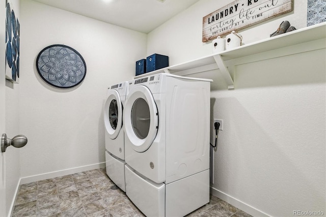 laundry area with laundry area, washer and clothes dryer, and baseboards