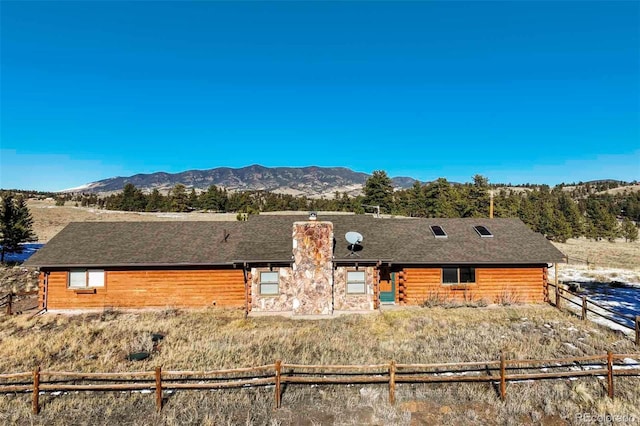 rear view of property with a mountain view