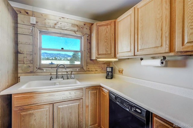 kitchen featuring dishwasher, sink, and wooden walls