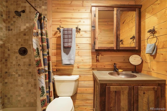 bathroom with vanity, wood walls, toilet, and curtained shower