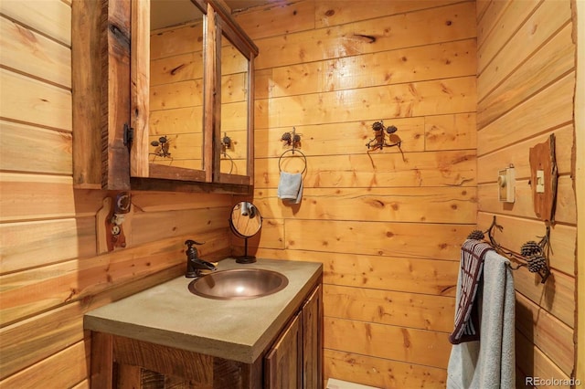 bathroom with wooden walls and vanity