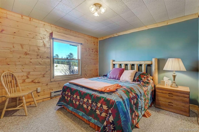 bedroom featuring light carpet, wooden walls, and a baseboard heating unit