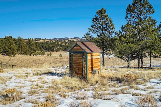 view of outbuilding with a mountain view and a rural view