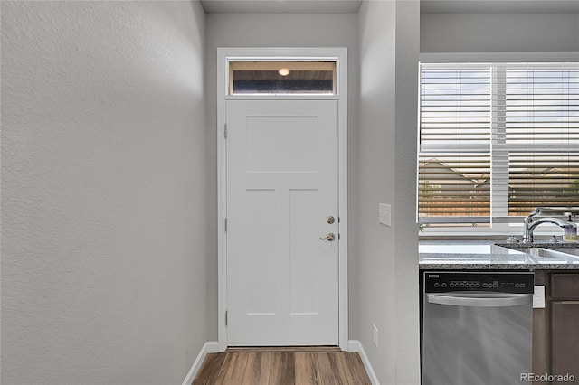847 Great Plains Ave, Berthoud, CO 80513 - doorway to outside featuring wood finished floors and a textured wall