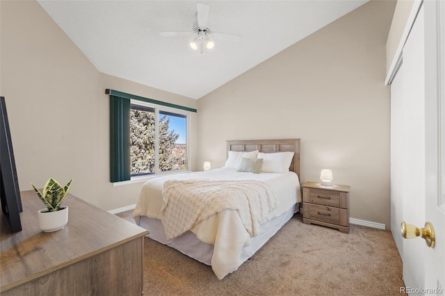 bedroom with ceiling fan, light colored carpet, and vaulted ceiling