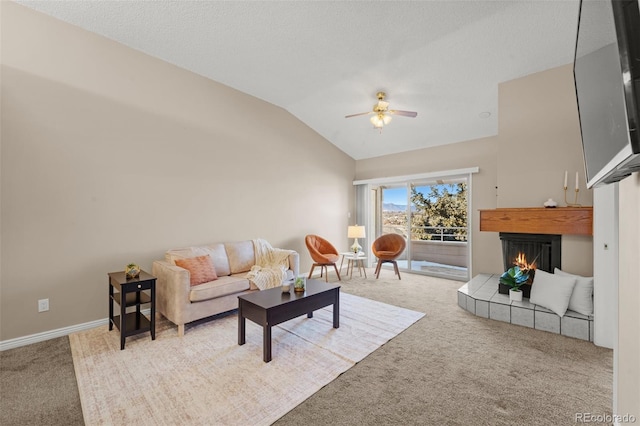 living room with a textured ceiling, light colored carpet, ceiling fan, and lofted ceiling