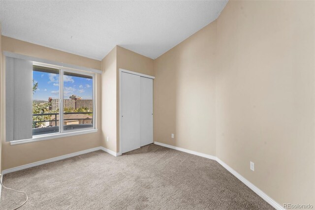 unfurnished bedroom with carpet and a closet