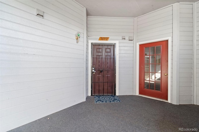 view of exterior entry with a porch