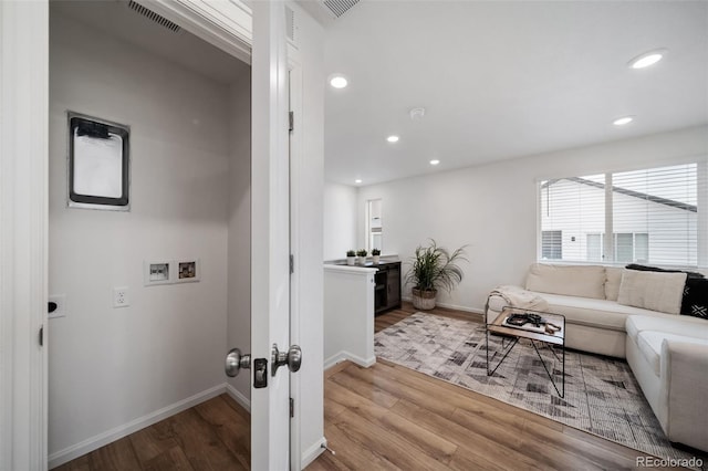 46558 Avery Ln, Bennett, CO 80102 - living area featuring baseboards, visible vents, recessed lighting, and wood finished floors