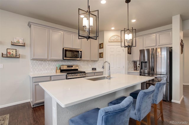 635 Silver Rock Trl, Castle Rock, CO 80104 - kitchen featuring appliances with stainless steel finishes, a sink, a chandelier, baseboards, and gray cabinets
