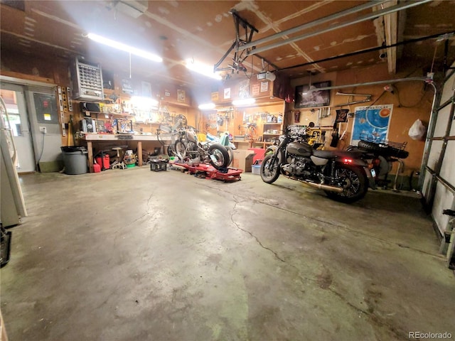 2115 Rangeview Dr, Pueblo, CO 81008 - garage featuring a workshop area and a garage door opener
