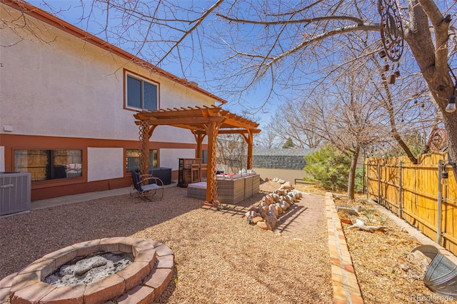 2115 Rangeview Dr, Pueblo, CO 81008 - fenced backyard featuring central air condition unit, an outdoor living space with a fire pit, a pergola, and a patio area