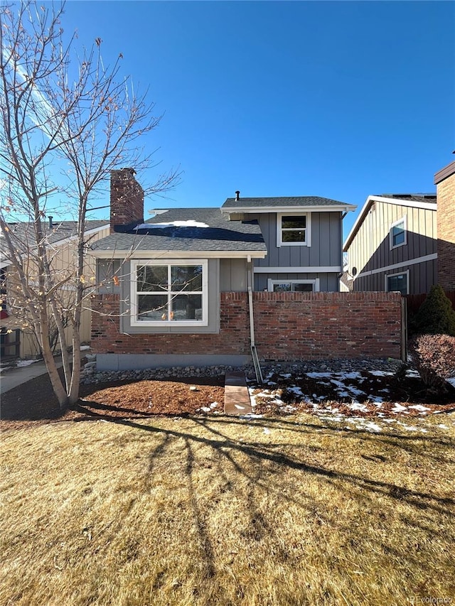 rear view of property with a yard