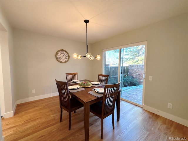 dining space with an inviting chandelier and light wood-type flooring