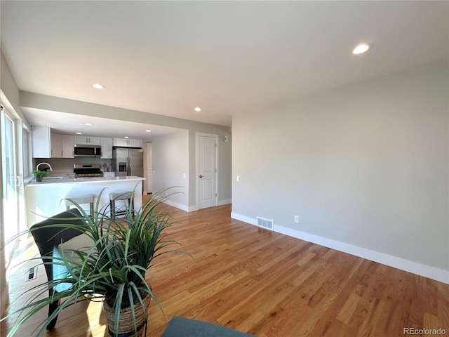 interior space with sink and light wood-type flooring