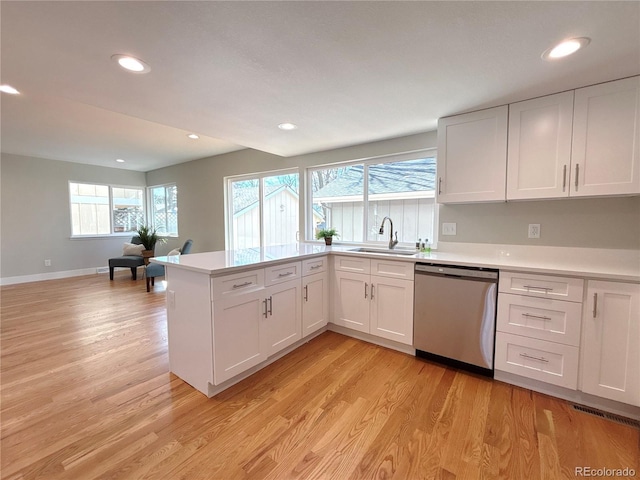 kitchen with white cabinetry, stainless steel dishwasher, plenty of natural light, and sink