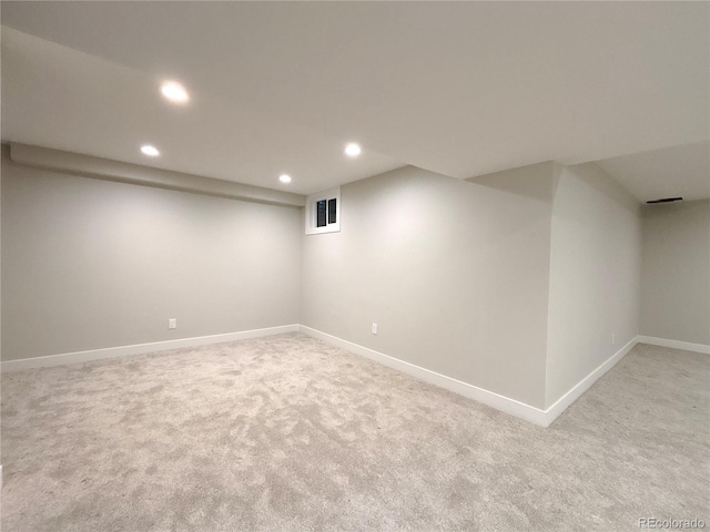 basement featuring light colored carpet