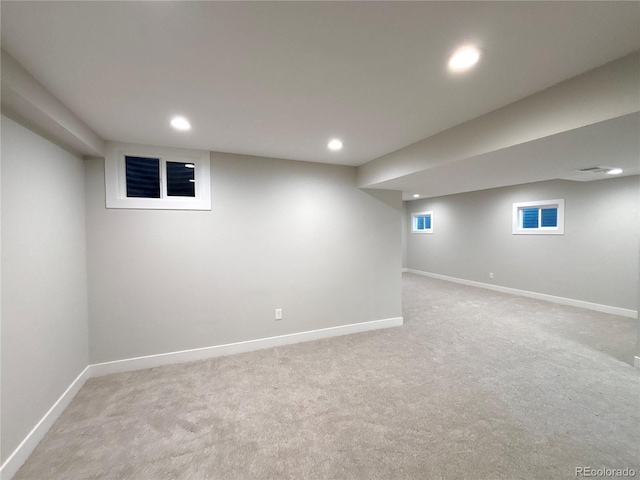 basement featuring light carpet