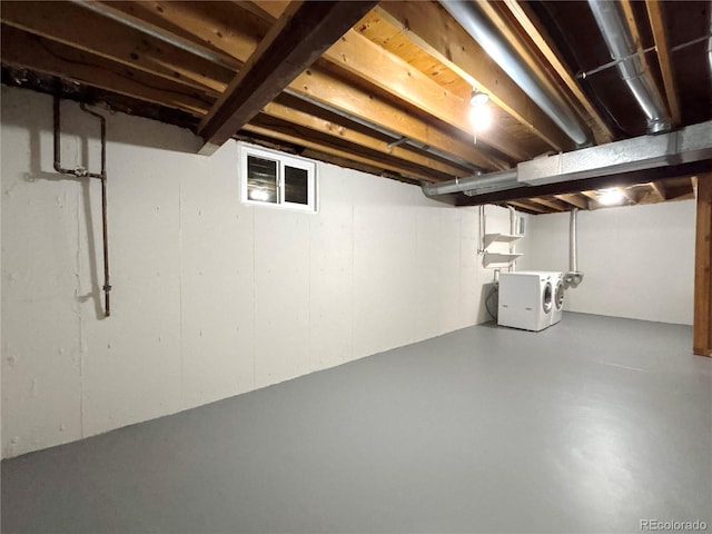 basement featuring washing machine and clothes dryer