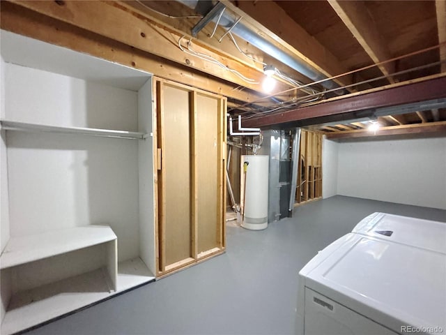 basement featuring gas water heater and separate washer and dryer