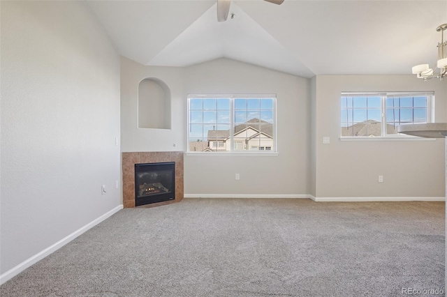5726 N Genoa Way Unit 301, Aurora, CO 80019 - unfurnished living room featuring carpet, a chandelier, a tile fireplace, vaulted ceiling, and ceiling fan