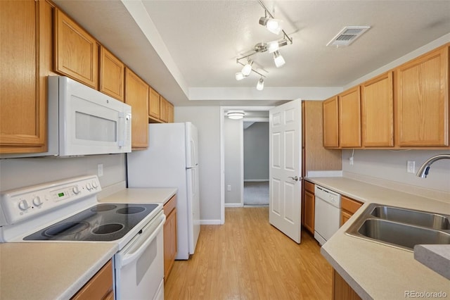 5726 N Genoa Way Unit 301, Aurora, CO 80019 - kitchen with white appliances, light wood-type flooring, light countertops, and track lighting