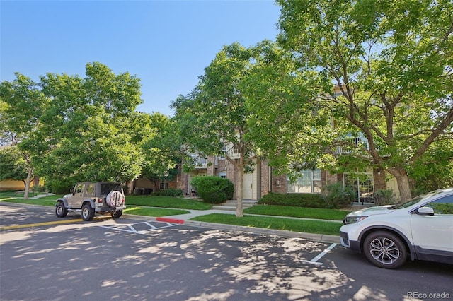 5726 N Genoa Way Unit 301, Aurora, CO 80019 - view of front of home with uncovered parking, brick siding, and a front lawn