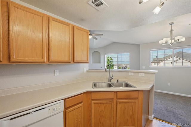 5726 N Genoa Way Unit 301, Aurora, CO 80019 - kitchen featuring white dishwasher, a peninsula, light countertops, lofted ceiling, and a ceiling fan