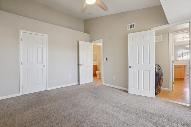 5726 N Genoa Way Unit 301, Aurora, CO 80019 - unfurnished bedroom featuring light colored carpet, high vaulted ceiling, connected bathroom, and washer and clothes dryer