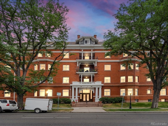 view of outdoor building at dusk