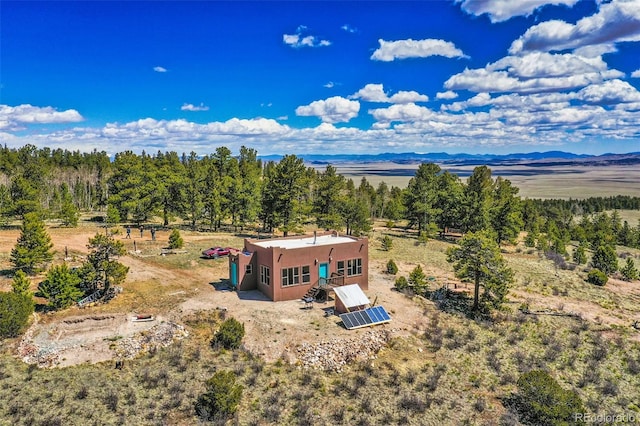 birds eye view of property with a mountain view and a rural view