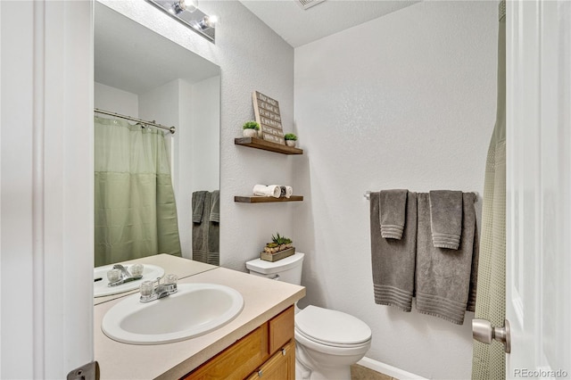 bathroom with visible vents, a textured wall, toilet, a shower with shower curtain, and vanity