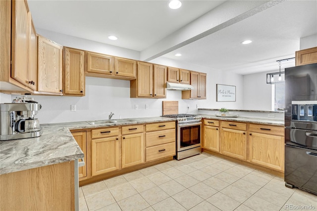 kitchen with recessed lighting, under cabinet range hood, a sink, black fridge, and stainless steel range with gas stovetop