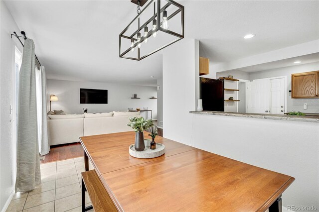 dining space with light tile patterned floors and recessed lighting