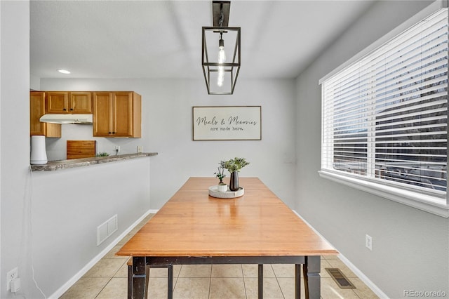 dining room with visible vents, baseboards, and light tile patterned floors