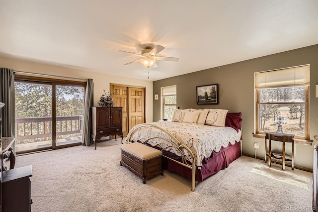 bedroom featuring access to exterior, light colored carpet, and a ceiling fan