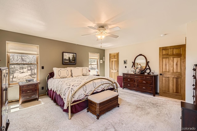 bedroom featuring light carpet and ceiling fan