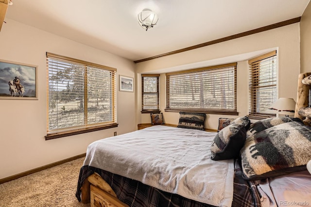 bedroom with ornamental molding, baseboards, and carpet