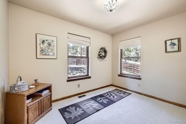 interior space with visible vents, a wealth of natural light, and light carpet