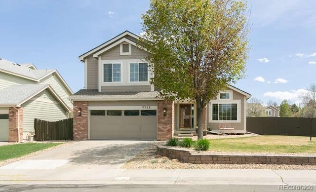 9768 Otis Dr, Westminster, CO 80021 - view of front of property with brick siding, fence, driveway, and a garage