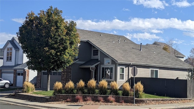 9768 Otis Dr, Westminster, CO 80021 - view of front facade with fence and a shingled roof
