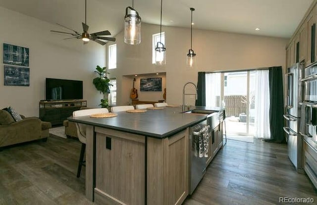 9768 Otis Dr, Westminster, CO 80021 - kitchen featuring a kitchen island with sink, stainless steel appliances, a wealth of natural light, and a sink