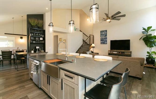 9768 Otis Dr, Westminster, CO 80021 - kitchen with dark countertops, a sink, dishwasher, a ceiling fan, and wood finished floors