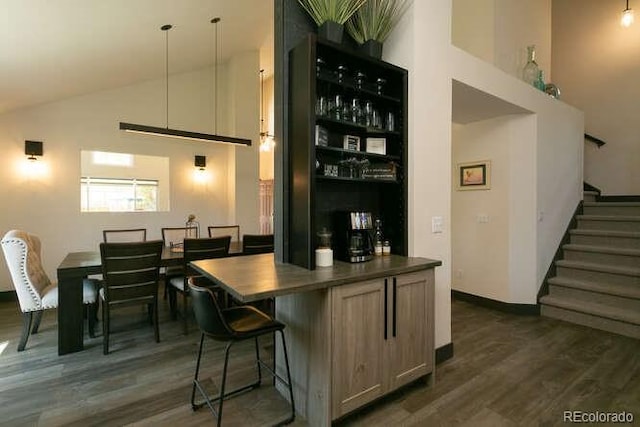 9768 Otis Dr, Westminster, CO 80021 - bar featuring stairs, high vaulted ceiling, and dark wood-type flooring