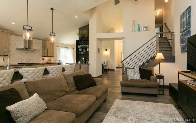 9768 Otis Dr, Westminster, CO 80021 - living room featuring stairway, high vaulted ceiling, recessed lighting, and wood finished floors